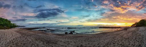 A panoramic shot of the sandy beach of the Pacific Ocean in Costa Rica at sunset