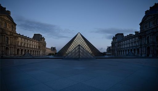 A beautiful view of the Louvre pyramid in Paris, France before dawn