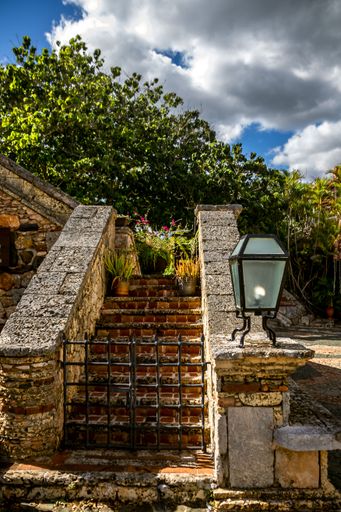 A vertical shot of closed metal bars in front of small stairs in Altos de Chavon, Dominican republic