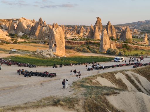 The quads and group of tourists near Cappadocia Fairy Chimneys