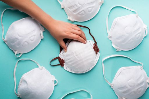 A closeup of a person's hands holding N95 respirator mask, a personal protective equipment against COVID-19