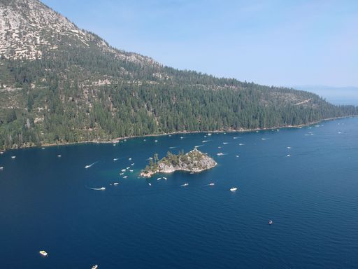 A drone view of the beautiful Emerald Bay full of white boats in Emerald Bay State Park, California