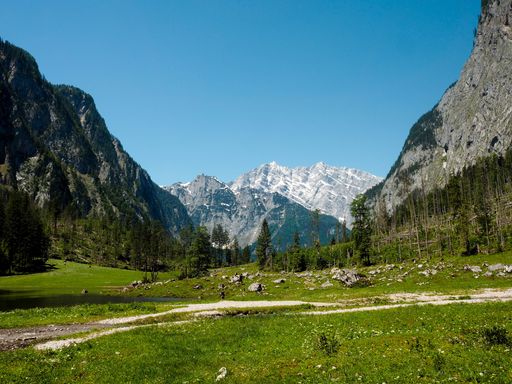 A beautiful scenery of a landscape with high rocky mountains covered with snow