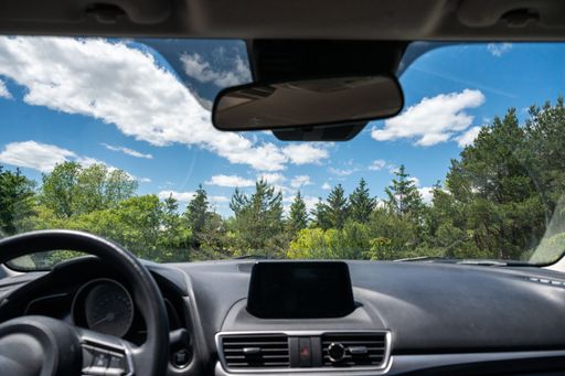 A beautiful landscape view with green nature seen from a car window