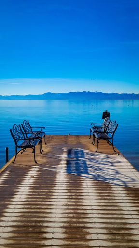 A beautiful view of benches on the pier on Lake Tahoe in the USA