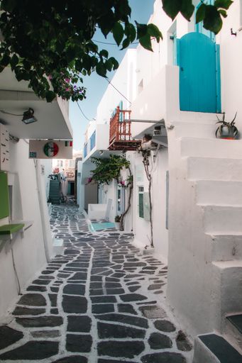 A beautiful narrow street with white houses in Naousa, Paros