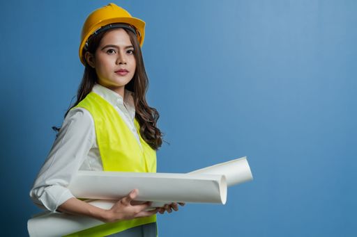 a female engineer holding manufacturing blueprints