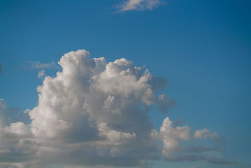 The beautiful white clouds on a bright blue sky background