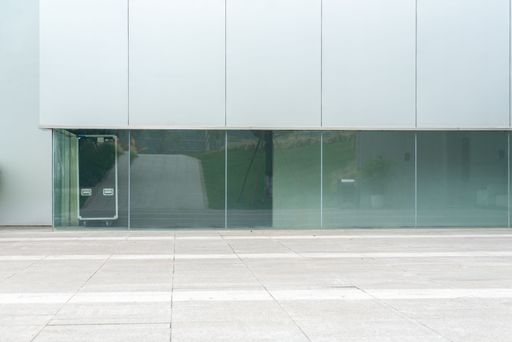 An empty ground floor in front of modern glass building