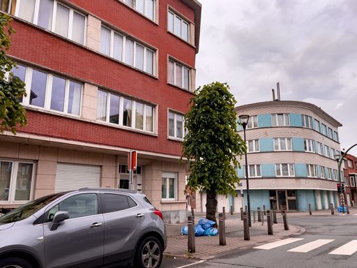 A car drives around an empty neighborhood in the morning in Belgium, Brussels