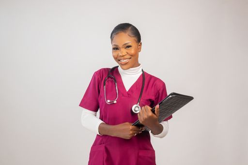 A beautiful nurse smiling while holding files