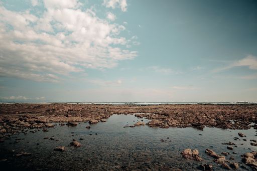 A rocky seabed at low tide or rocky beach at cape Uvita, Costa Rica ,under blue cloudy sky