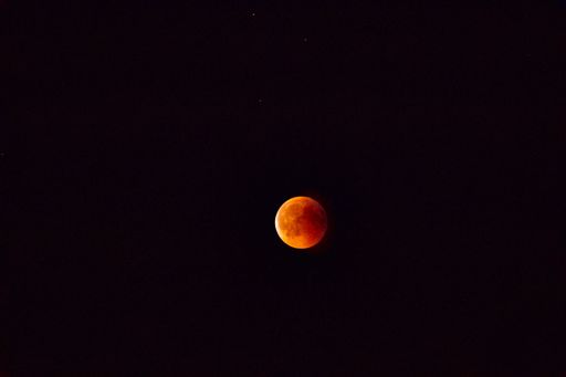 A mesmerizing view of a moon in the dark black sky at night