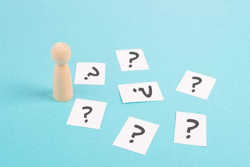 Man is thinking, question marks, brainstorming and looking for answers, solving a problem, making a decision, business and education concept
