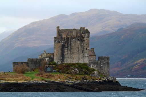 A beautiful view of the Eilean Donan castle surrounded by water and mountains
