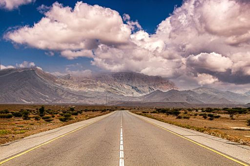 A beautiful road leading to the mountains on a sunny day