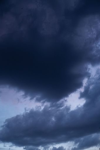 A Dramatic shot of a dark blue cloudy sky