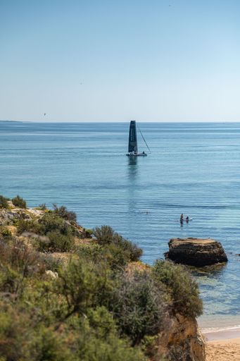 A vertical shot of the rocky coast on a sunny day in Lagos, Portugal