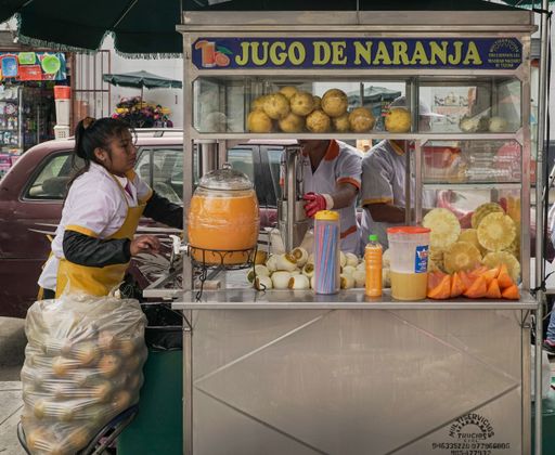 A closeup of an orange juice stand outside the Mercado Central in Lima, Peru