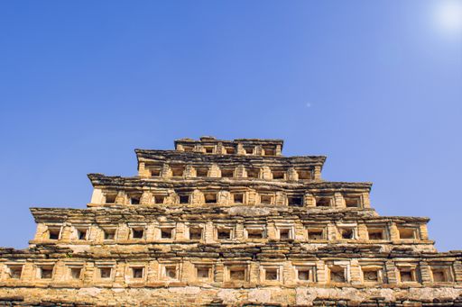 A low angle shot of El Tajin in Jose, Mexico with a blue background