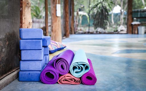 Yoga mats rolled up inside a unique outdoor yoga studio geared toward yoga-minded travelers and tourists.