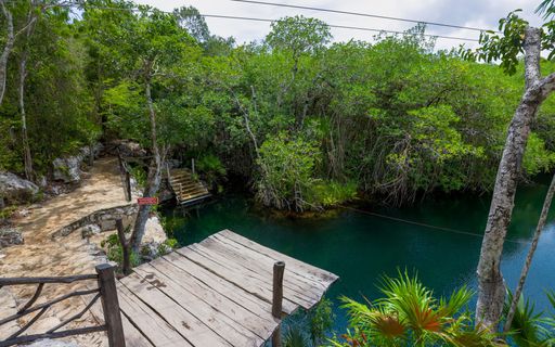 A jumping platform allows adventurous swimmers to dive into Cenote Jaguar from 20 feet high.