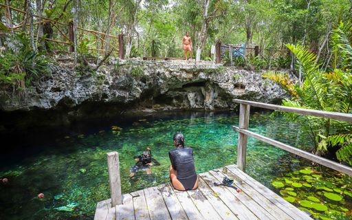 Visitors enjoy swimming in Cenote Nic Te Ha, one of several cenotes in the Parque Dos Ojos complex.