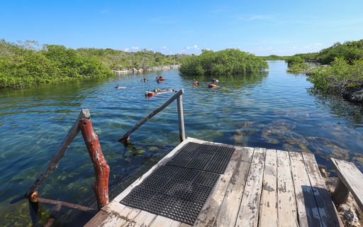 Snorkelers and swimmers in the water at Yal-Ku Lagoon and cenote near Akumal Beach.