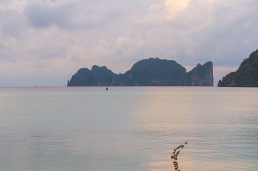 A beautiful view of a calm sea and big rocks on a cloudy day in Koh Lanta, Thailand