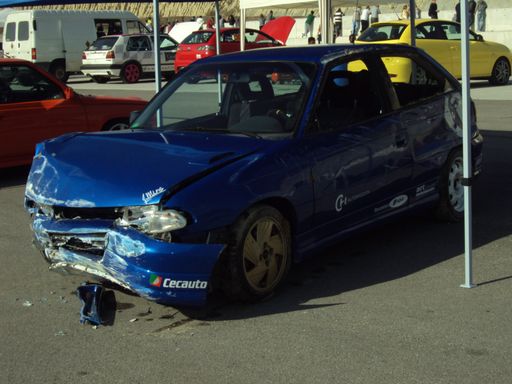 A crashed blue Opel Astra GSI parked on the street