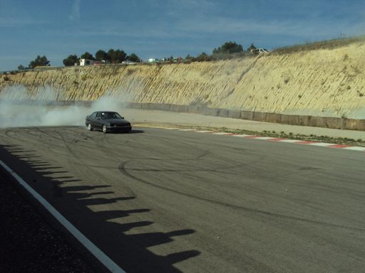 A classic black Opel Omega in a race track