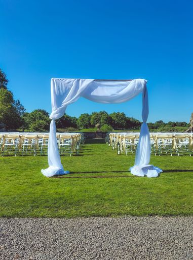 The vertical view of an empty outdoor wedding venue under the blue sky