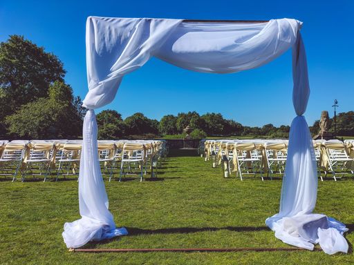 The view of an outdoor wedding venue empty chairs under the blue sky