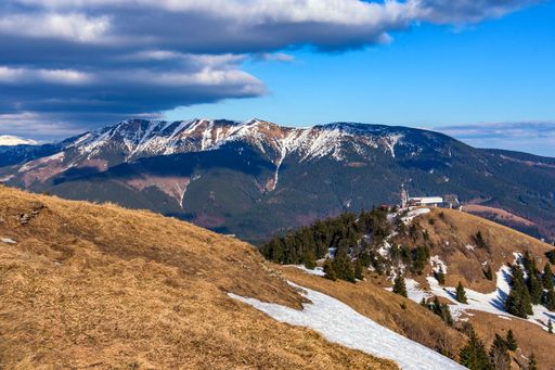 A beautiful shot of mountains partly covered in snow