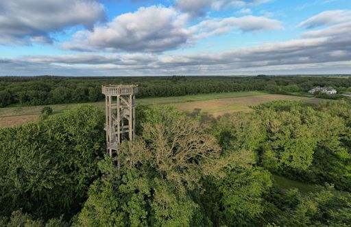 An aerial shot of the watchtower Belvedere near the city Heerenveen under cloudy sky