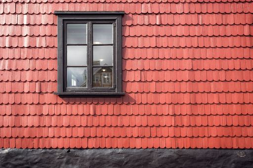 A closeup shot of a wooden window on the clay roof tiles captured at daylight