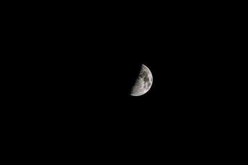 A half moon in the black sky