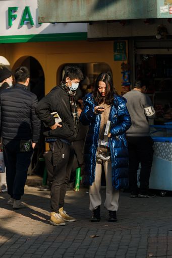 A vertical shot of a young couple of Shanghai on the streets in China