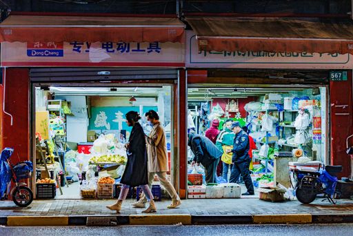 The people walking around and shopping in a store at night in Shanghai, China