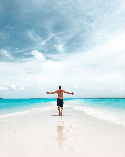 A beautiful shot of a man enjoying the perfect weather at the beach