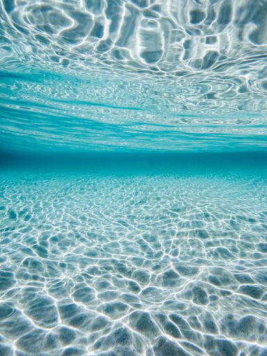 A vertical shot of a blue underwater background