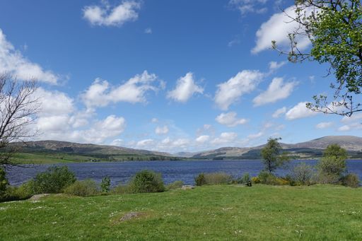 A view of the Clatteringshaws Loch in Scotland on a sunny day