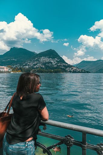 A vertical shot of female model looking to the sea in Monte Bre Lugano Switzerland