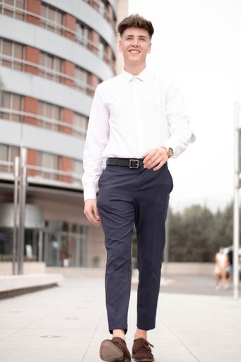 A handsome young business boy posing on a street