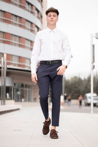 A handsome young business boy posing on a street