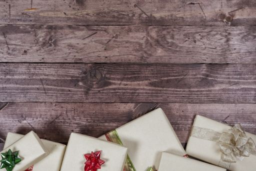 An overhead shot of present on a wooden surface great for writing text or background