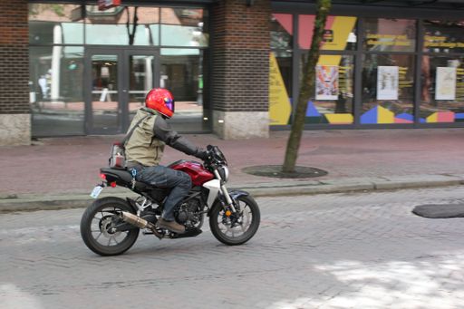 A person riding a motorcycle in downtown Vancouver, British Columbia, Canada