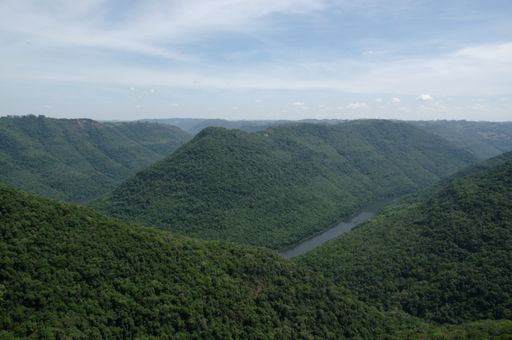 A beautiful shot of a river flowing in the middle of the mountains under the clear sky