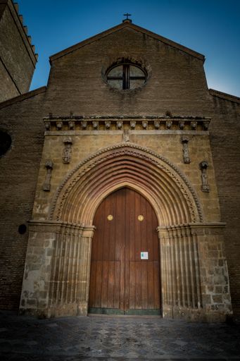 A vertical shot of the facade of an old historic church in Seville old town, Spain