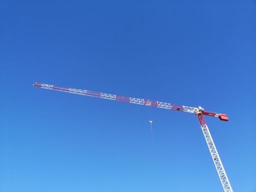 A high angle shot of a crane isolated on clear sky background